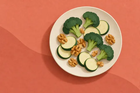 Paper collage of broccoli, courgette and walnuts on a cream plate