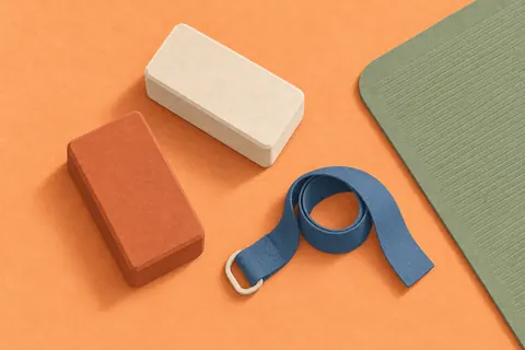 Paper collage of yoga blocks, a strap and a sage mat
